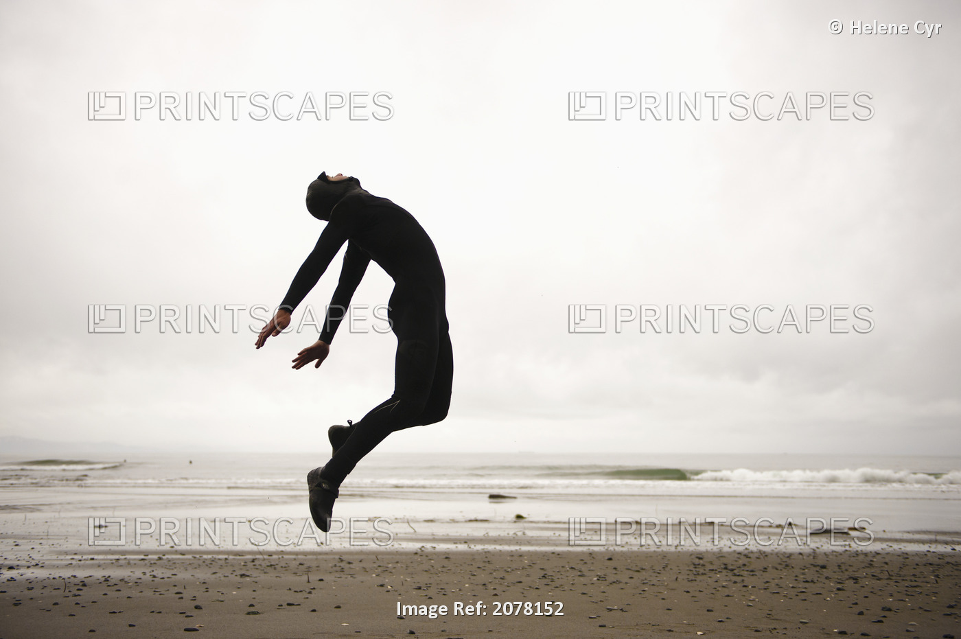 An Individual Wearing A Wet Suit Jumping In Mid-Air On A Beach; French Beach, ...