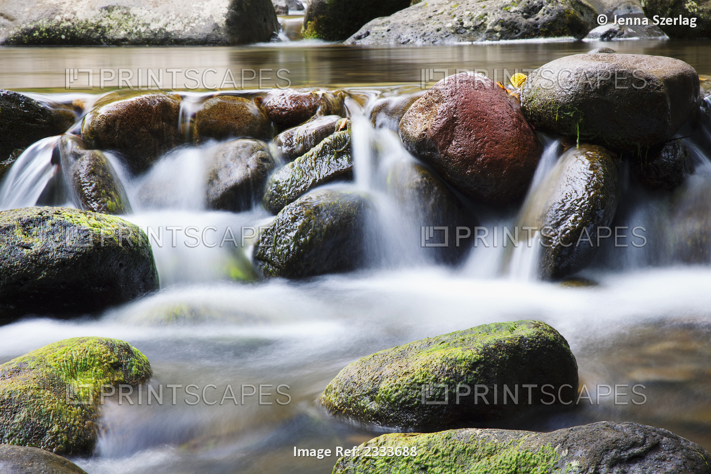 A close up of water in a river spilling over rocks; Maui hawaii united states ...