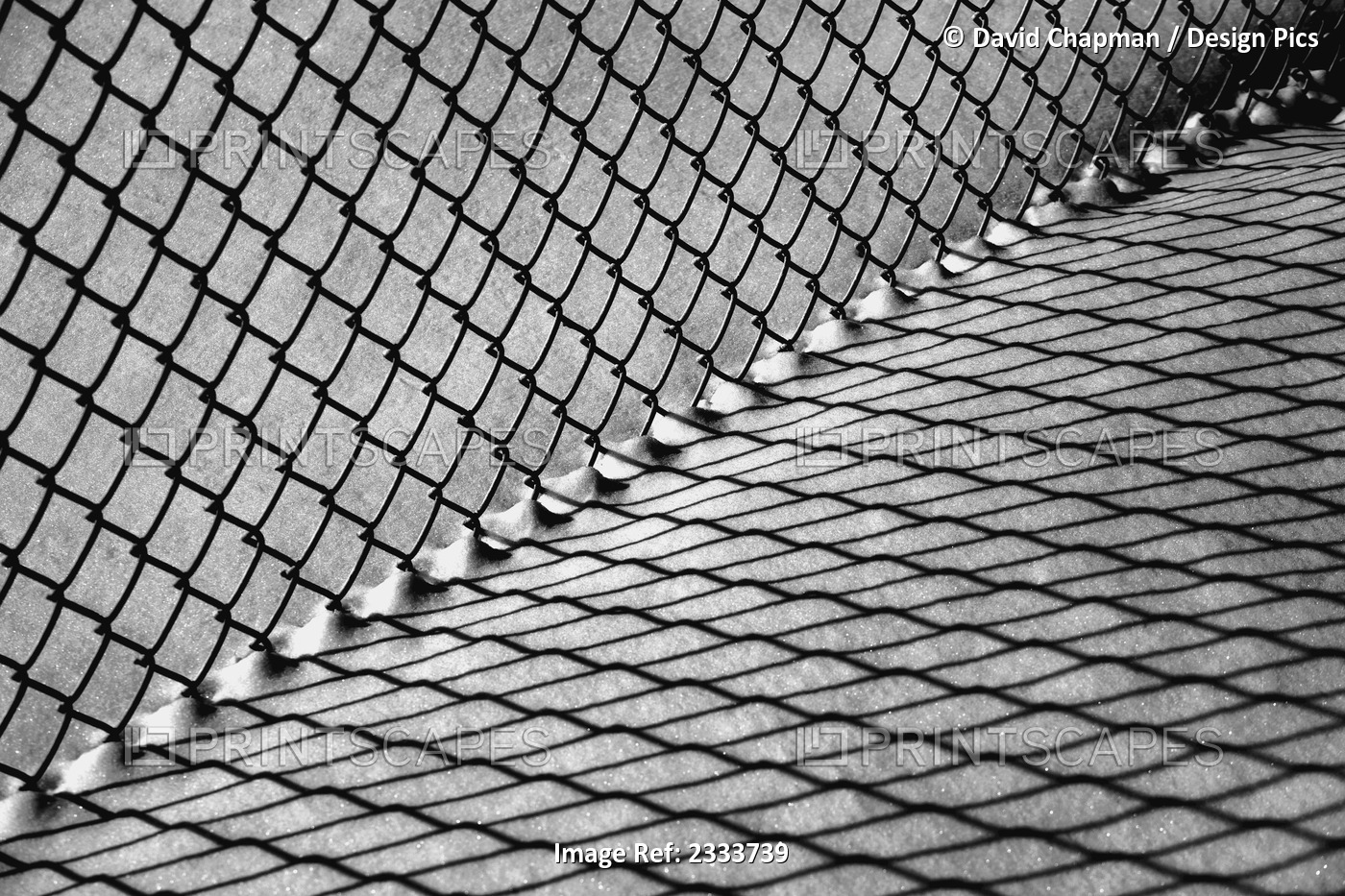 Chain link fence and shadow on snow; Waterloo, Quebec, Canada
