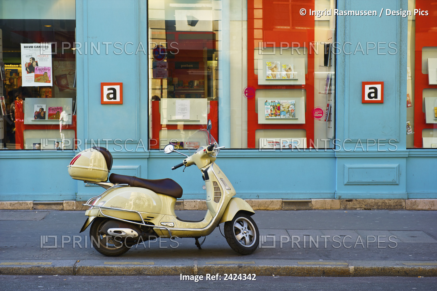 A Motorized Scooter Parked Outside A Blue Building Along A Street, Canal Saint ...