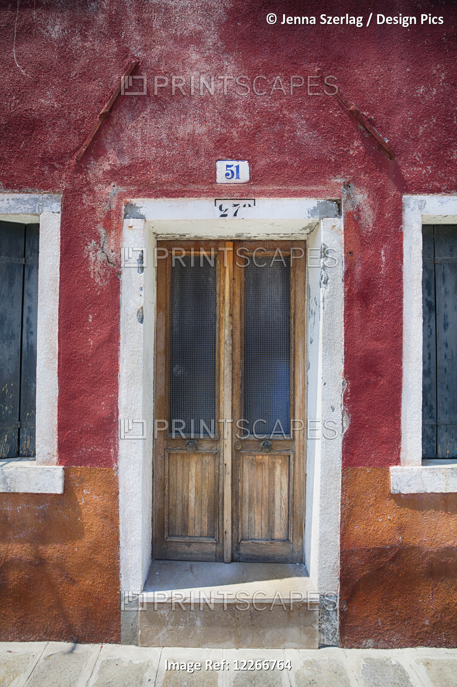 A Close View Of A Door On A Rustic Red House; Burano, Venice, Italy