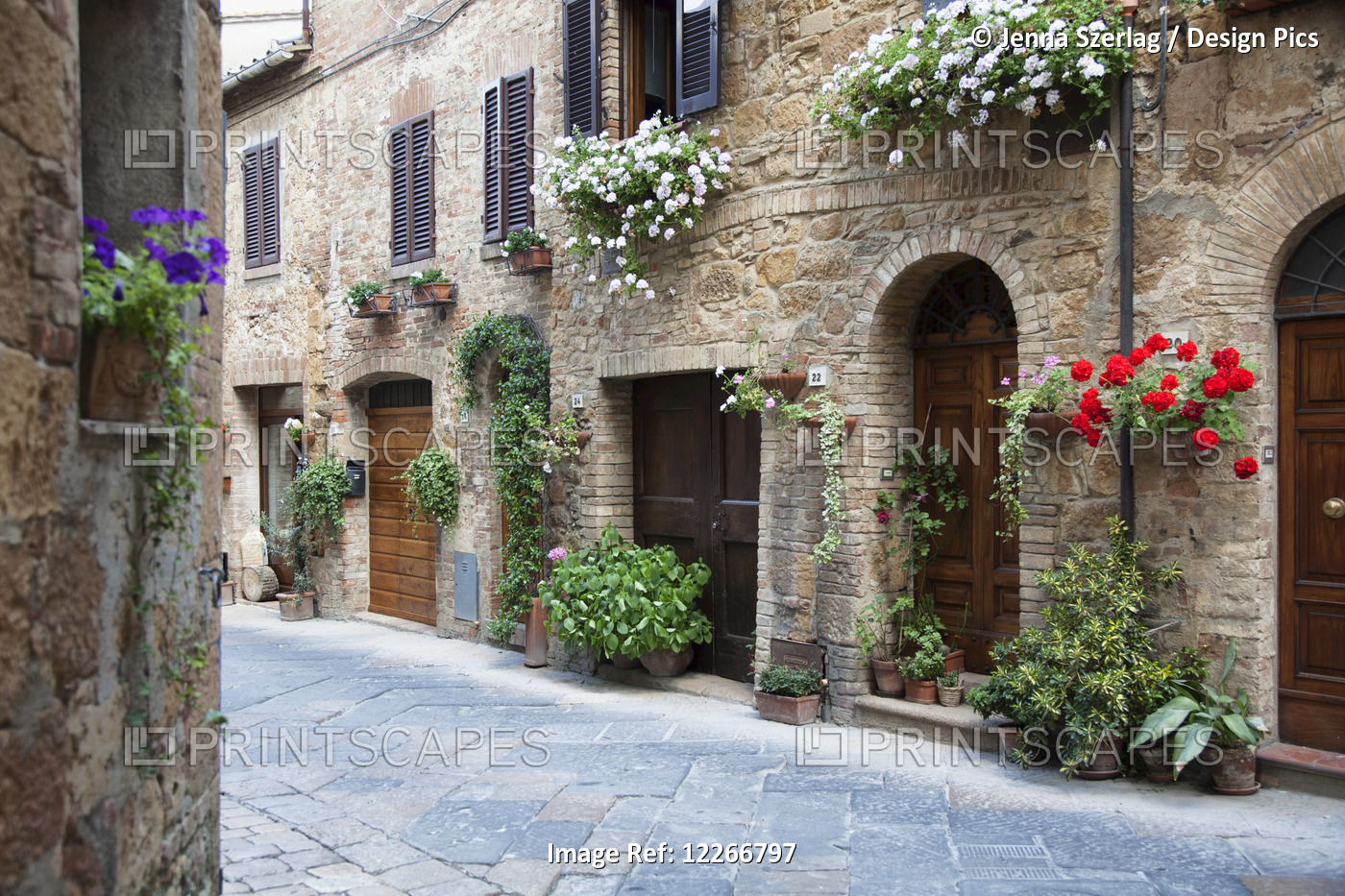 A Quaint Village With Flowers Decorating Residential Buildings; Pienza, ...