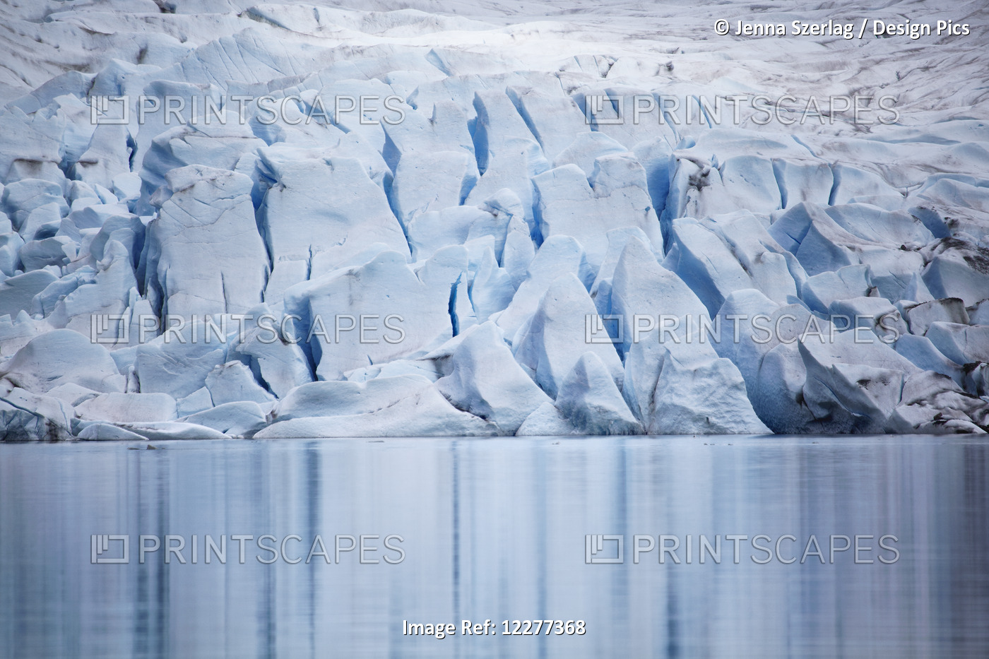 Scenic View Of The Face Of Mendenhall Glacier Reflecting In Lake Water, Juneau, ...