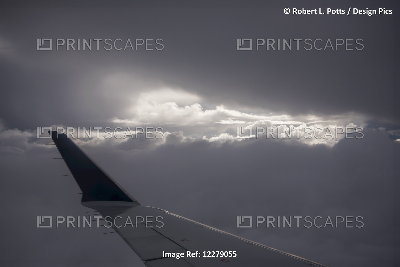 Wing Of An Airplane With Sunlight Shining Through Storm Clouds; Astoria, ...