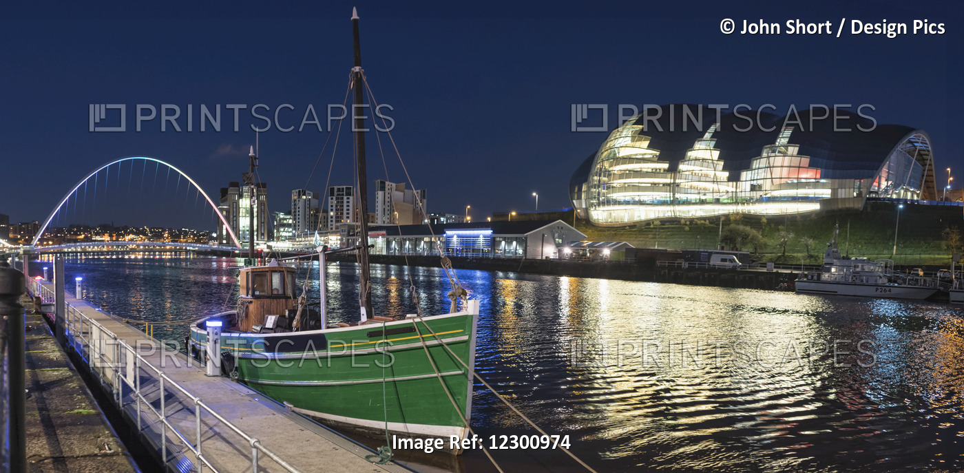 A Green Fishing Boat Moored Along The Edge Of A River At Nighttime With An ...