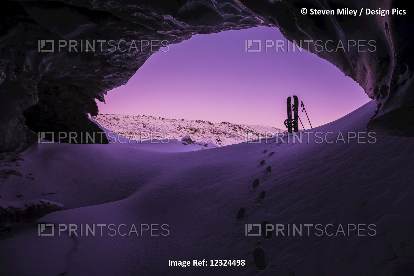 Footprints Lead Toward A Splitboard Placed At The Entrance Of An Ice Cave ...