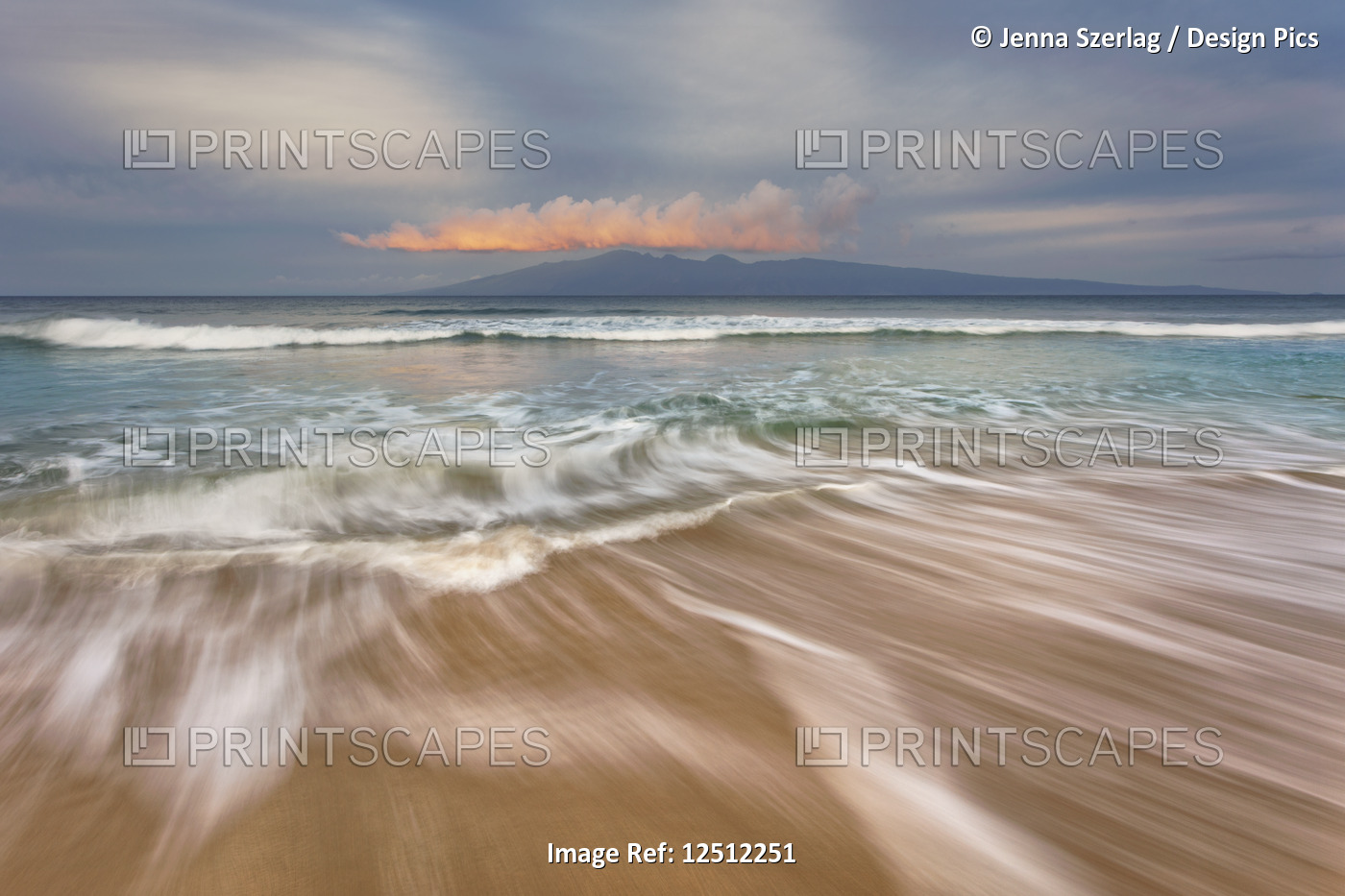 Soft water stretches across the sand at sunrise with a view of Molokai; Maui, ...